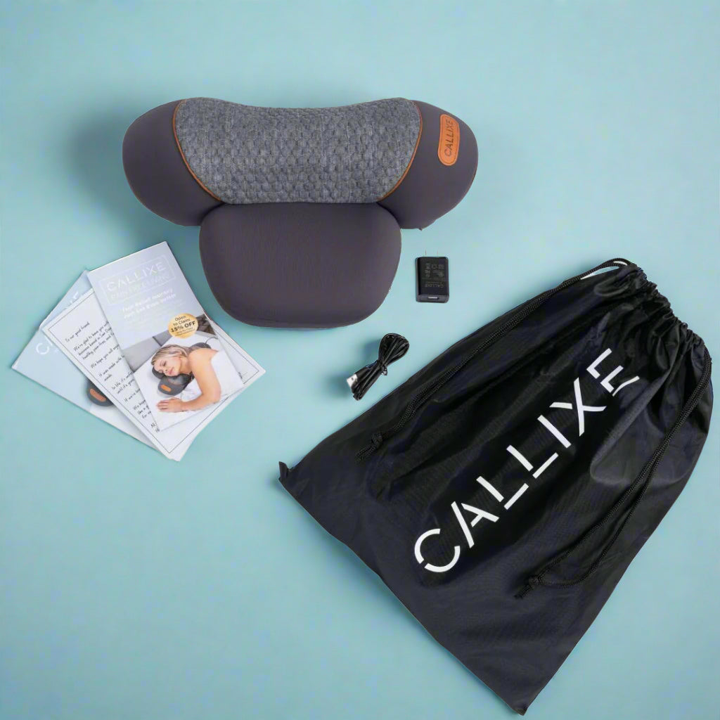 Gray travel pillow with accessories on a light blue background